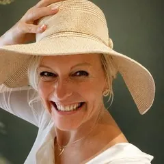 Olga Reyes-Busch mit Strohhut, lachend